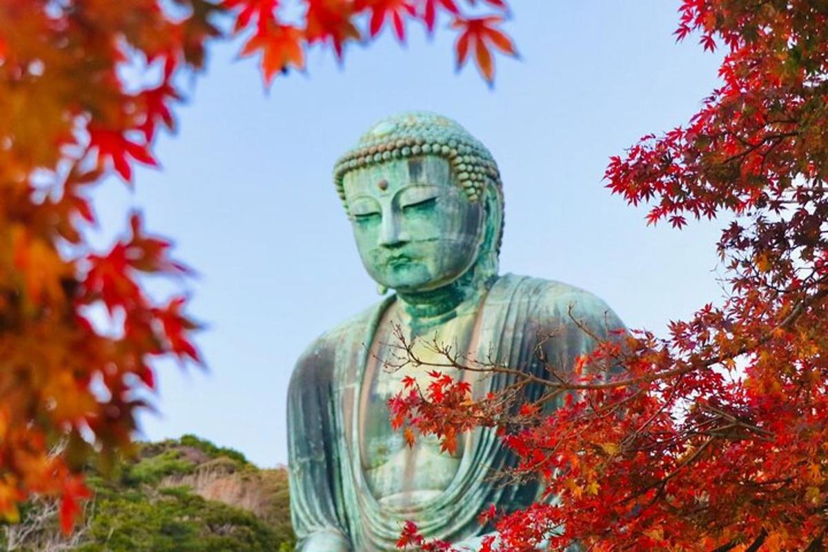 a large statue of a buddha sitting next to trees