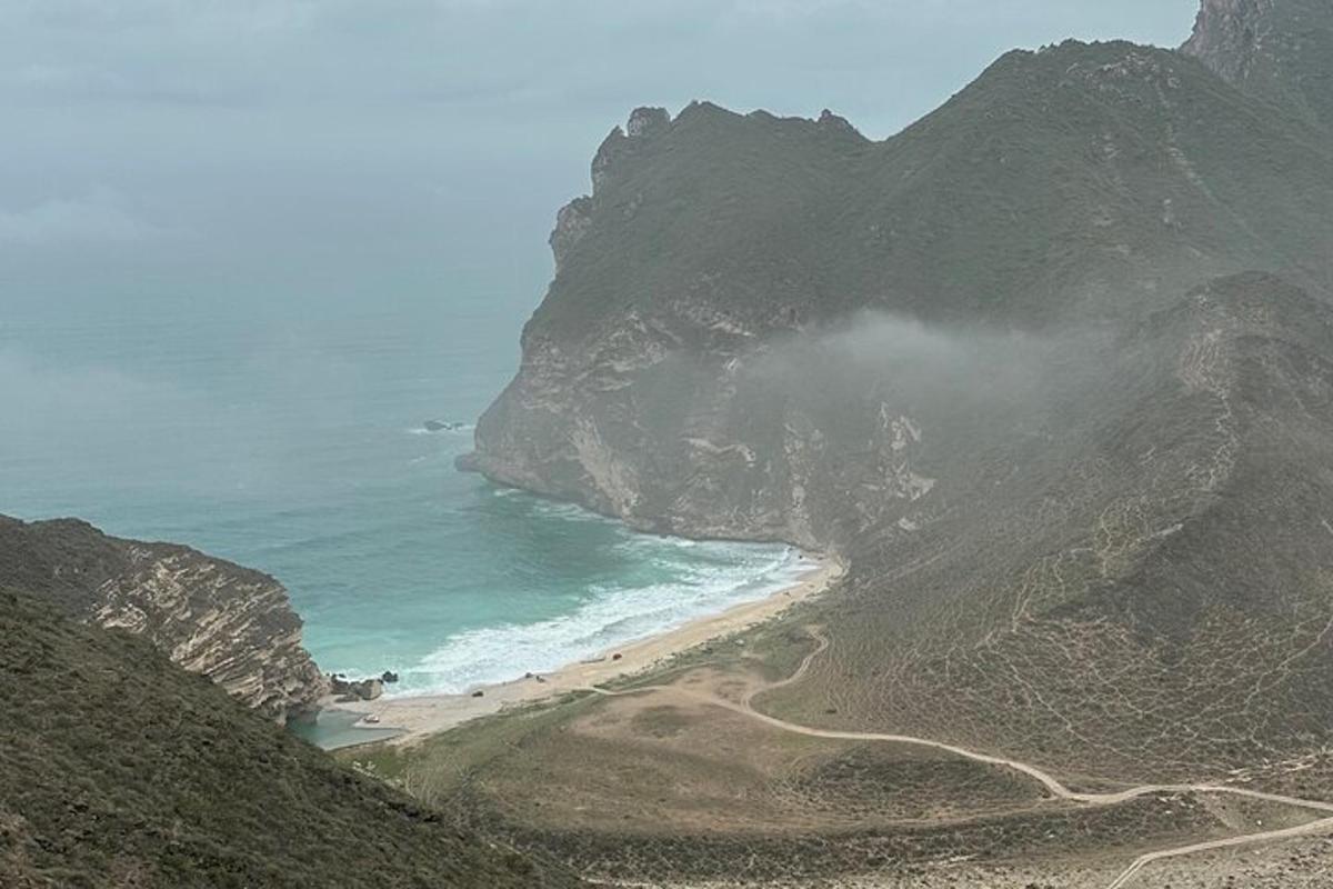a view of the ocean and a beach on a mountain