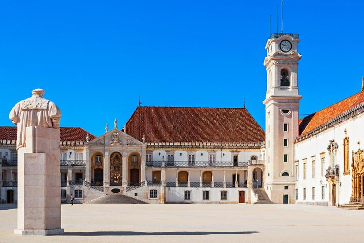 a large building with a clock tower and a statue