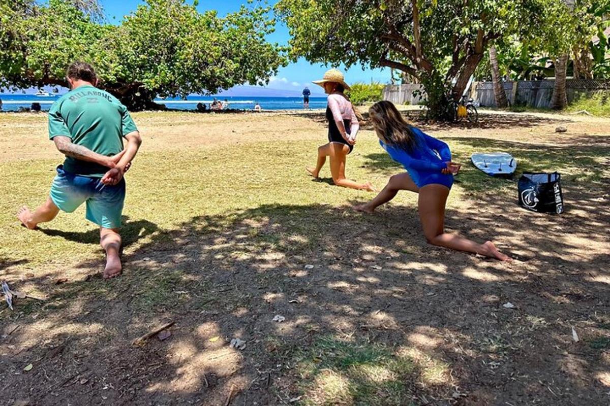 a group of people playing frisbee on the beach