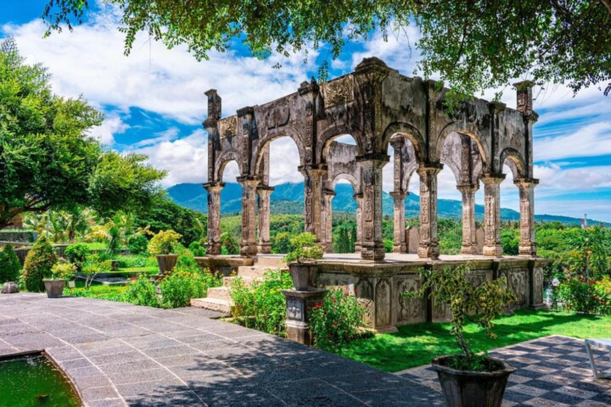 um edifício antigo com colunas e arcos em um jardim