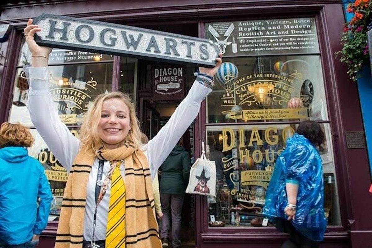 a woman holding up a sign in front of a store