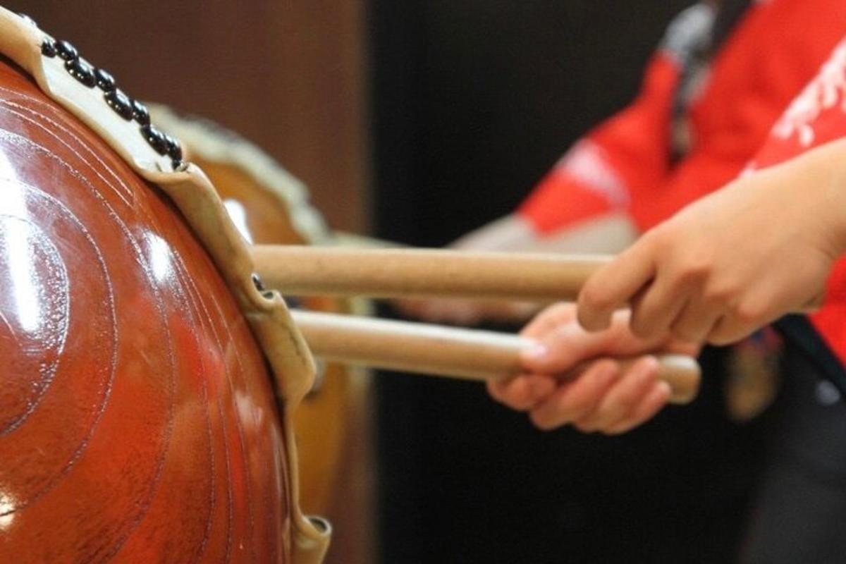 a person hitting a drum with a stick