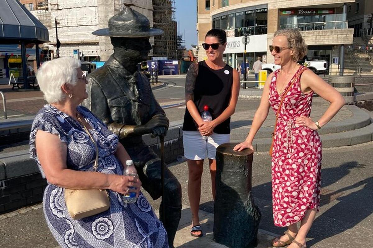 three women are standing next to a statue