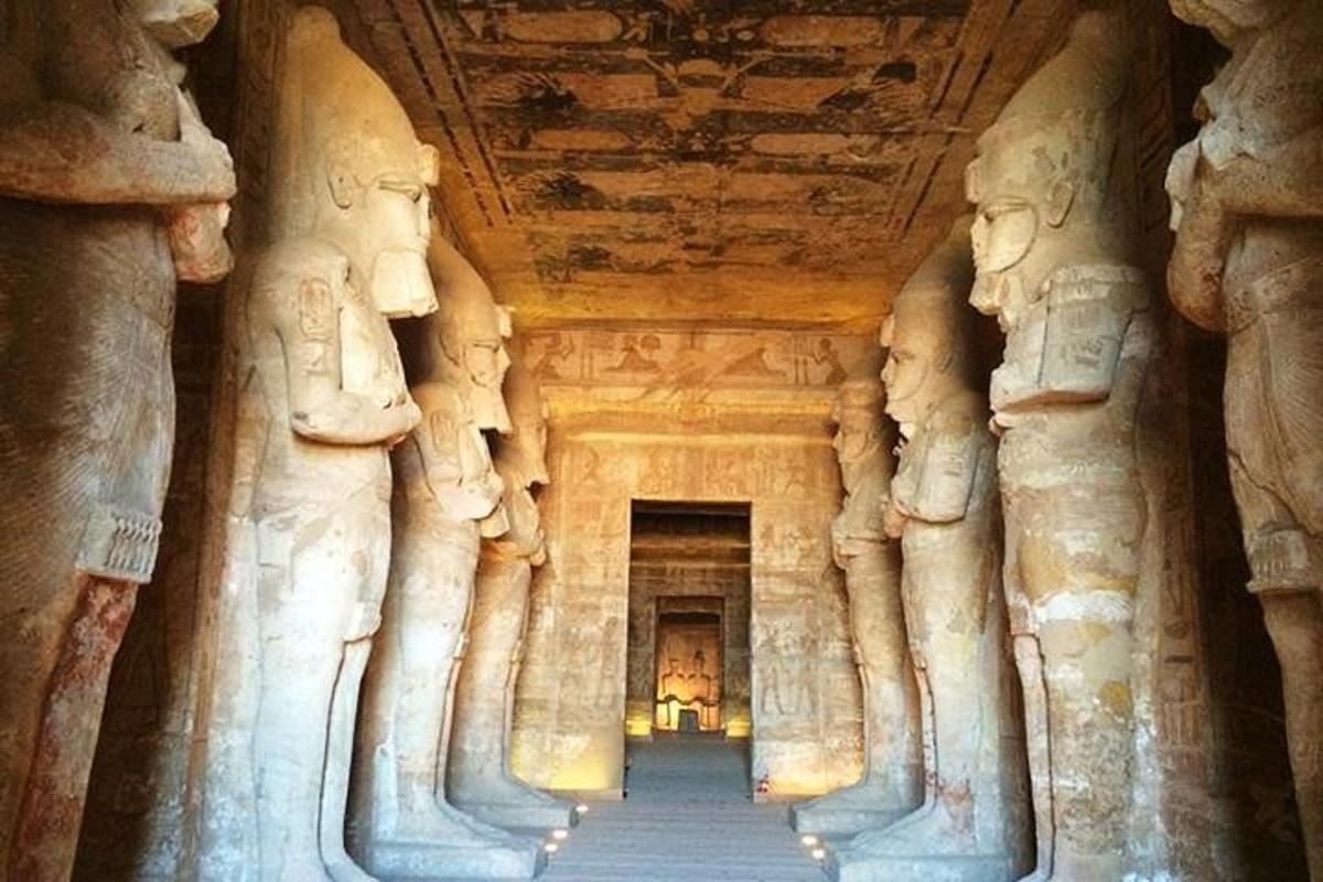 a hallway in an ancient building with stone statues