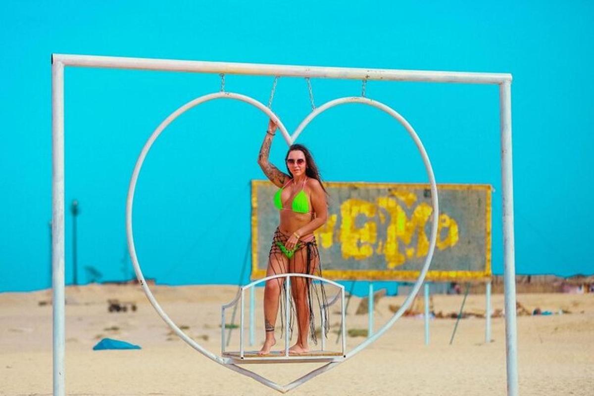 a woman in a hoop on the beach