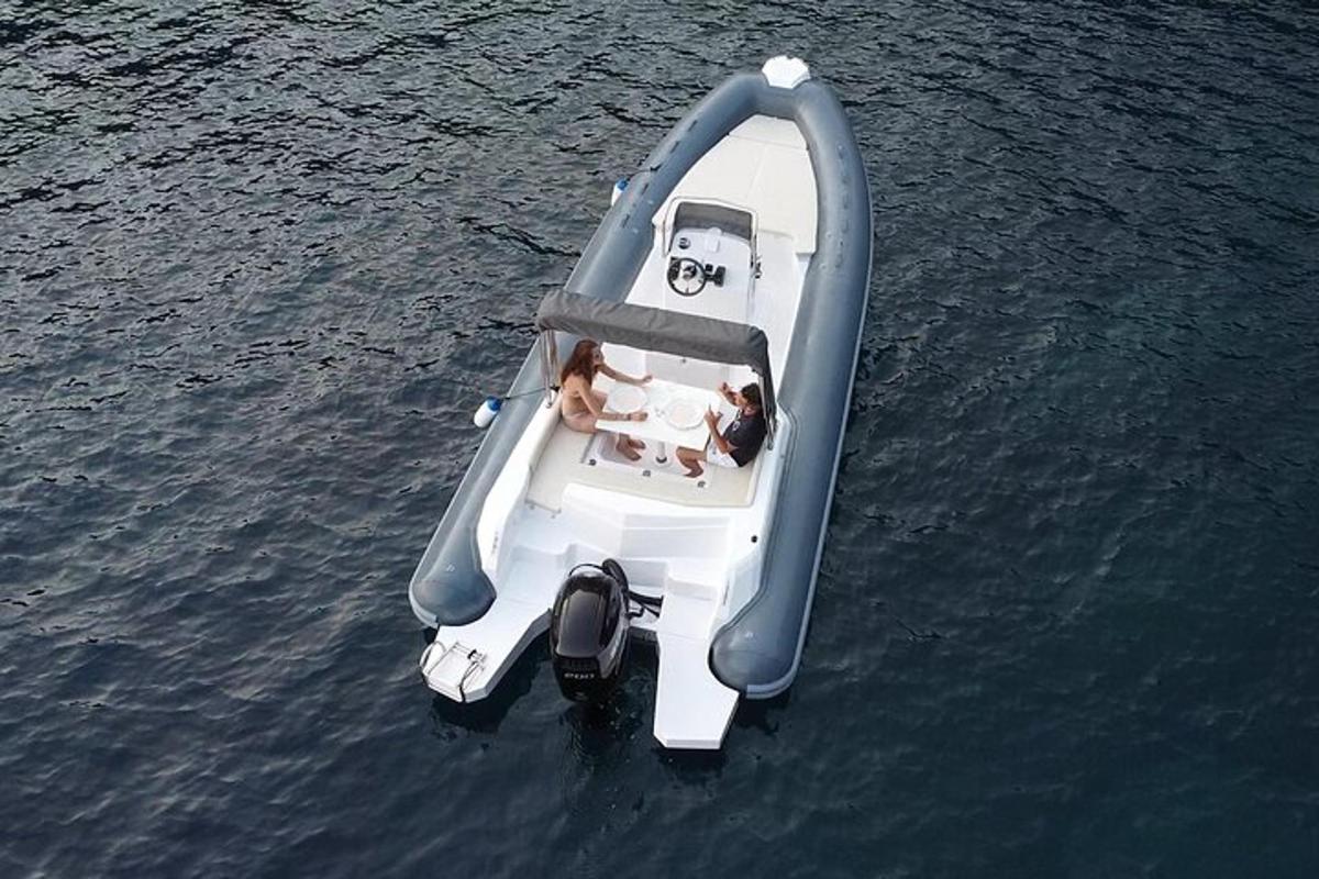 a boat in the water with two people in it