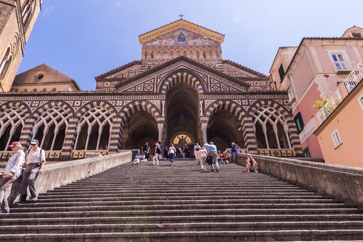 a group of people walking down the stairs in front of a building