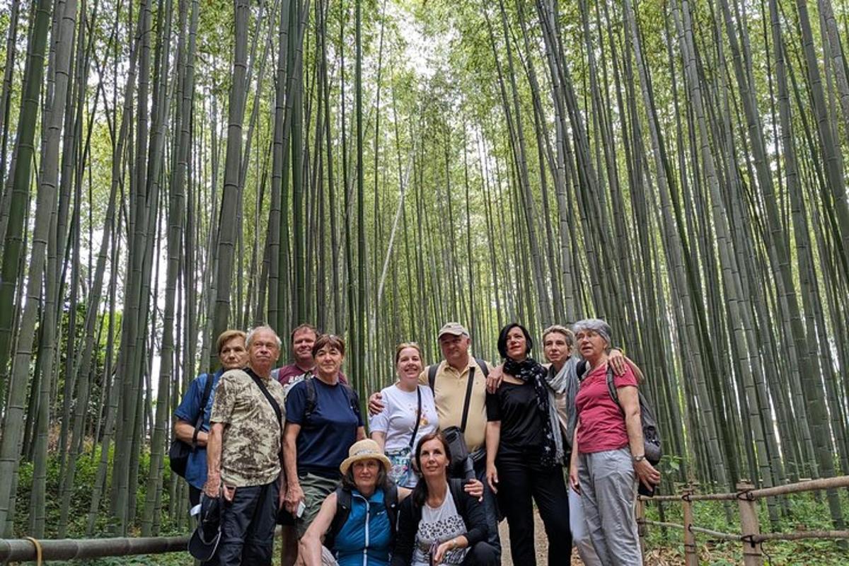 a group of people posing for a picture in a bamboo forest