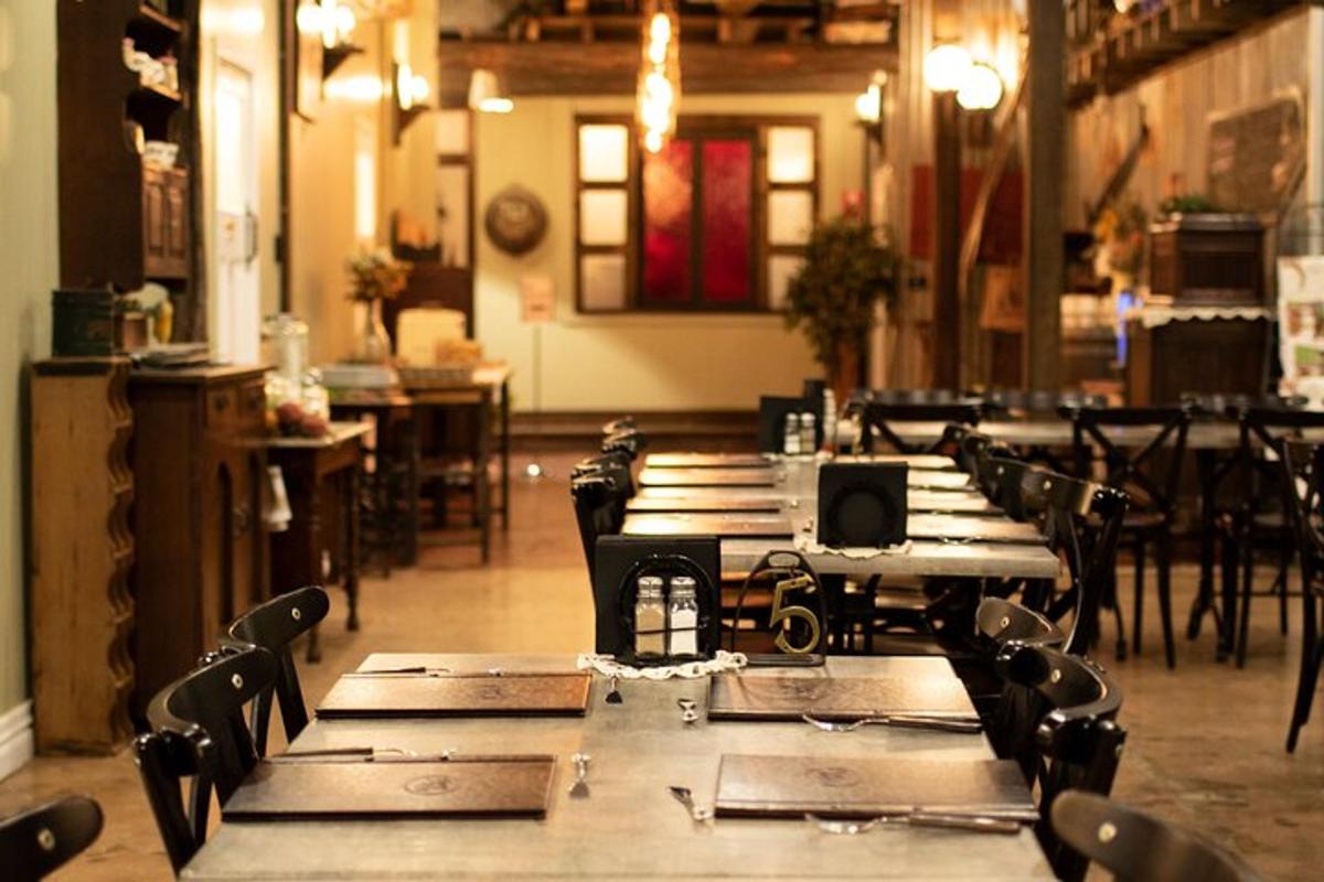 a row of wooden tables and chairs in a room