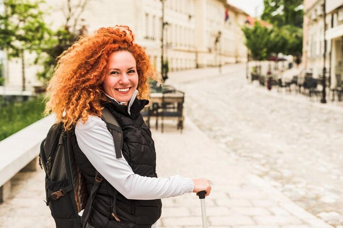 a woman with red curly hair standing on a street