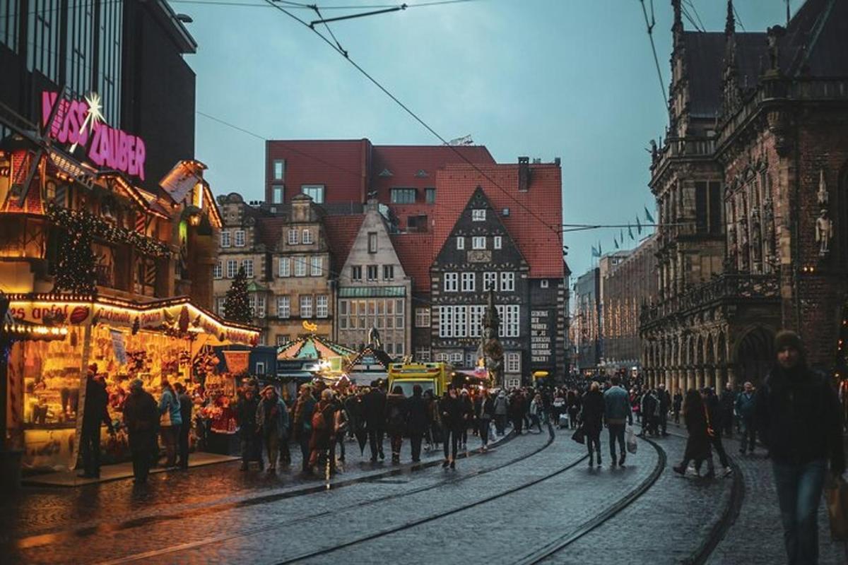 a crowd of people walking down a street in a city
