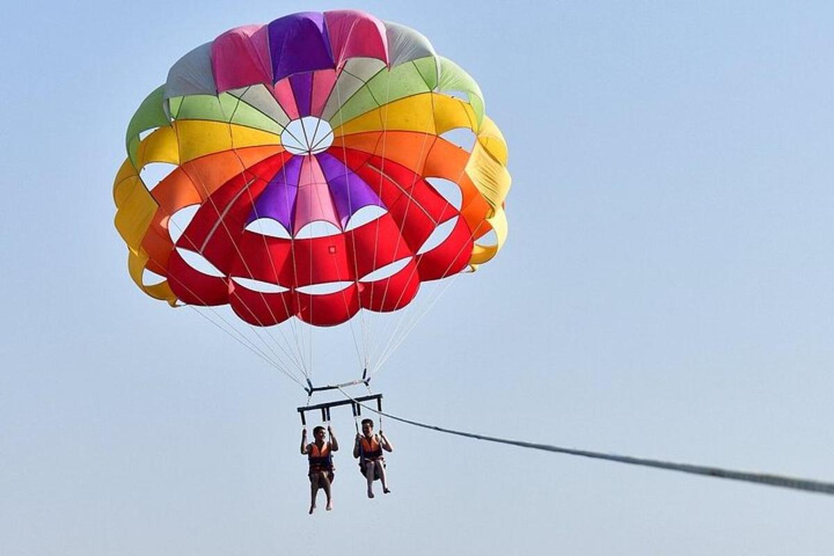two people are riding a parachute in the sky