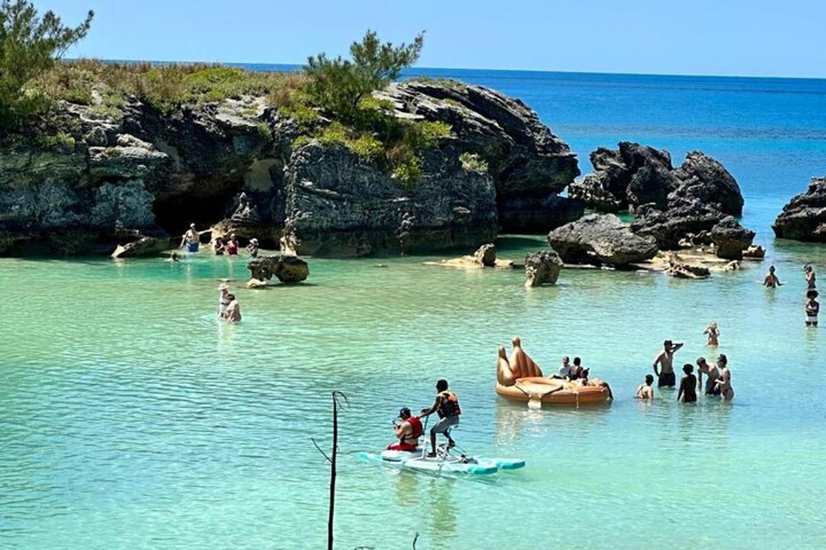 a group of people in the water at a beach