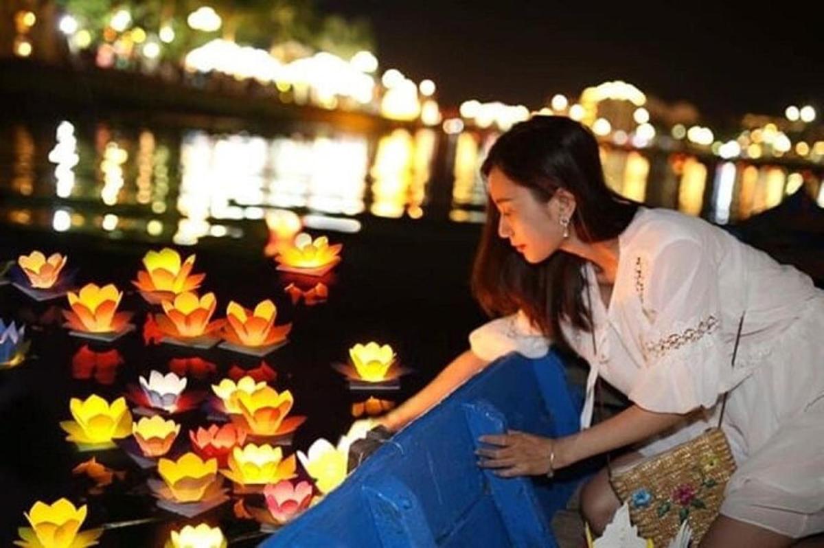una donna che guarda una mostra di fiori di carta