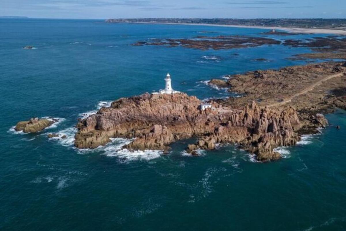 a lighthouse on a small island in the ocean