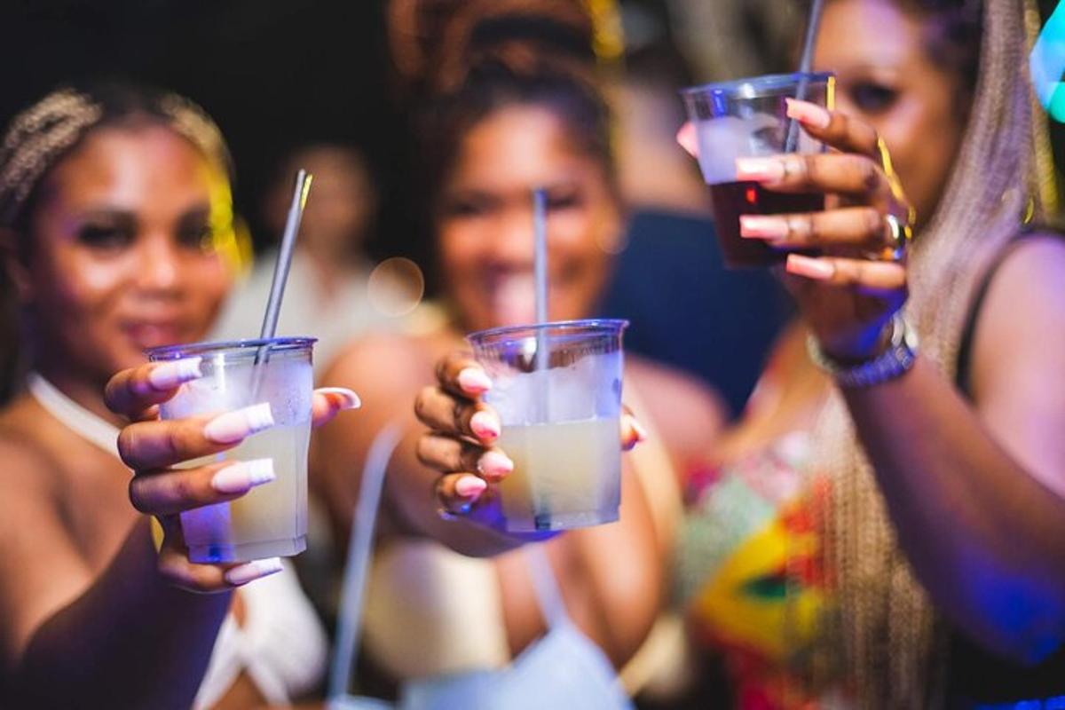 two women holding up drinks in their hands