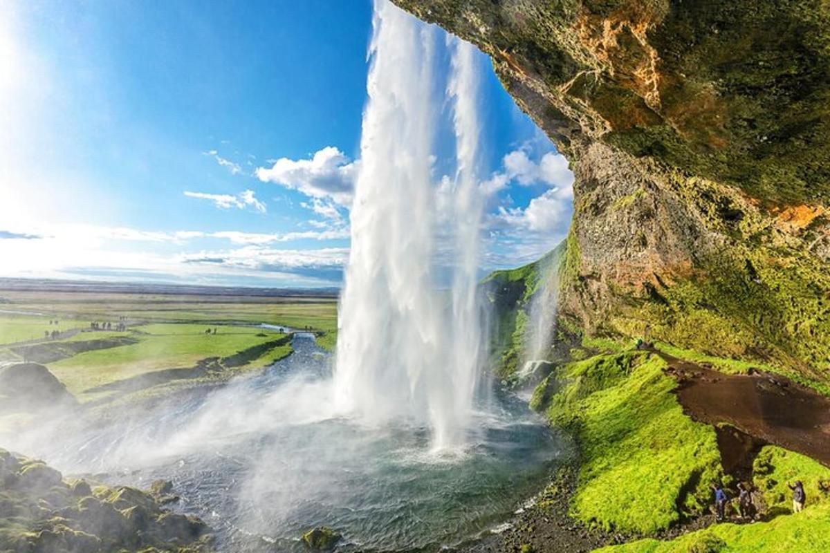 an aerial view of a waterfall on a cliff