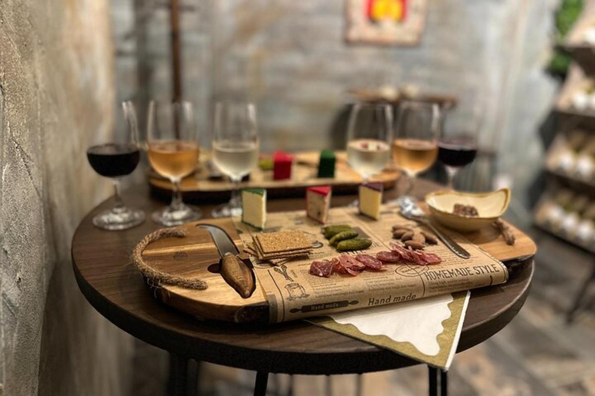 a wooden table with glasses of wine and food on it