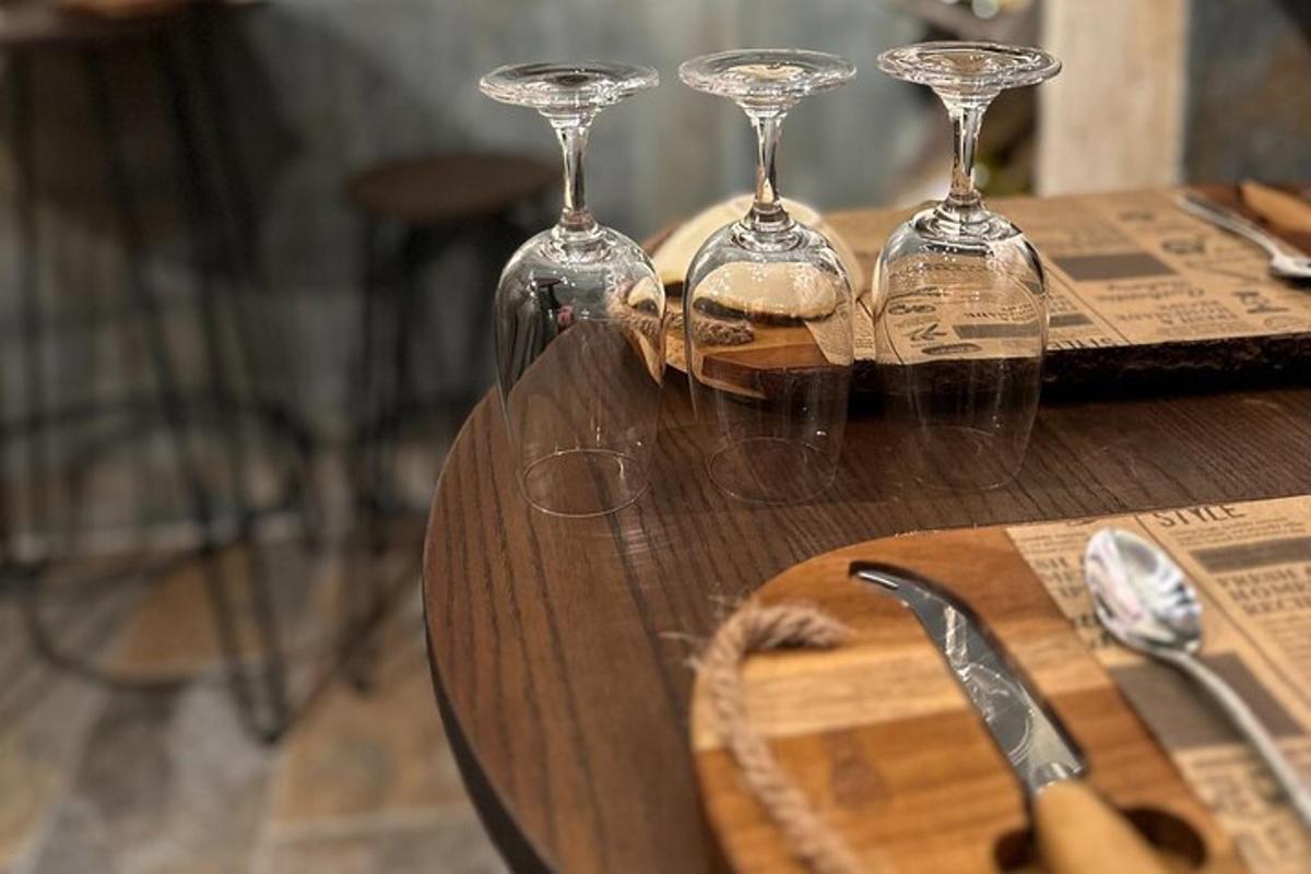 a group of wine glasses sitting on a wooden table
