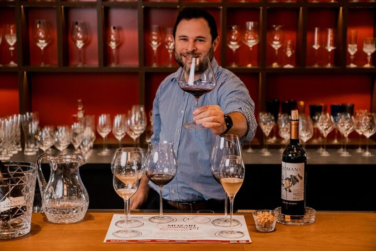 a man is holding up a glass of wine