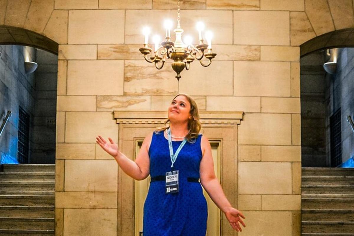 a woman in a blue dress standing in front of stairs