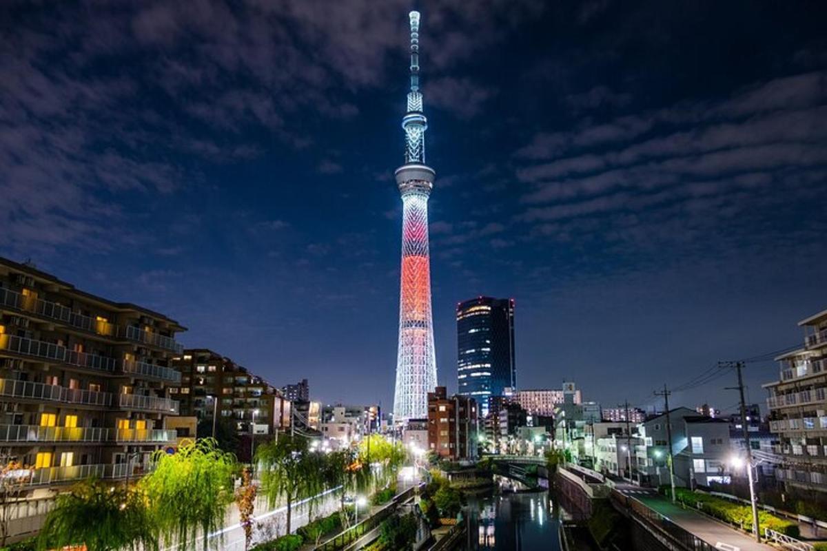 una torre alta il·luminada en vermell i blanc