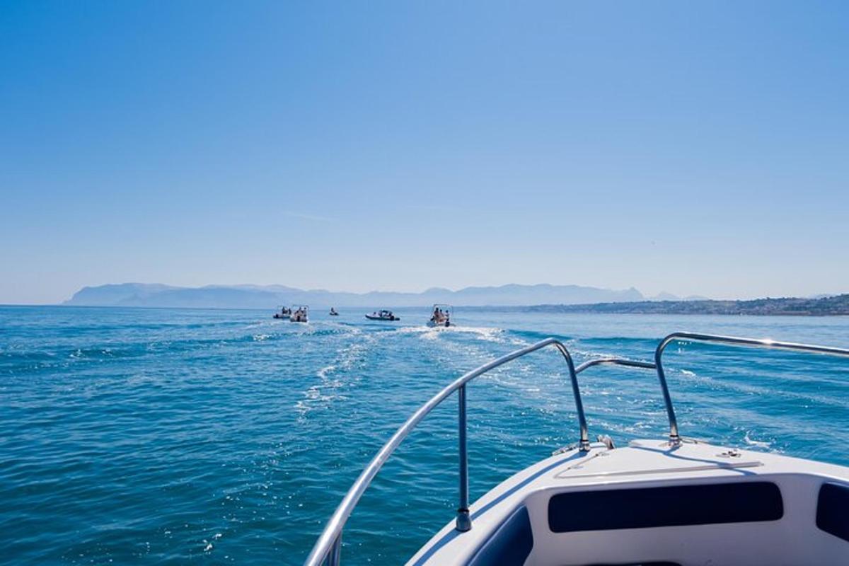 a boat in the water with a group of people in the ocean