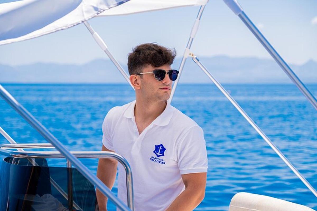 a man wearing sunglasses and a white shirt on a boat