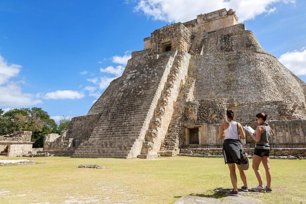 two people standing in front of a pyramid