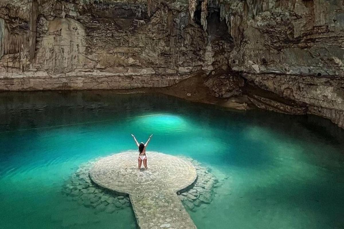 a woman standing on a rock in a pool of water