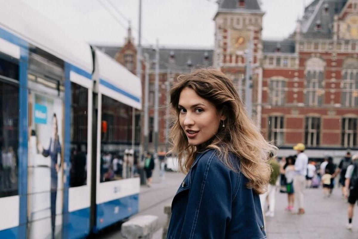 a woman standing in front of a bus