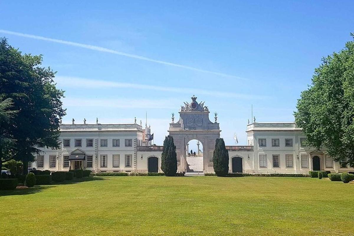 ein großes weißes Gebäude mit einem großen Rasenplatz