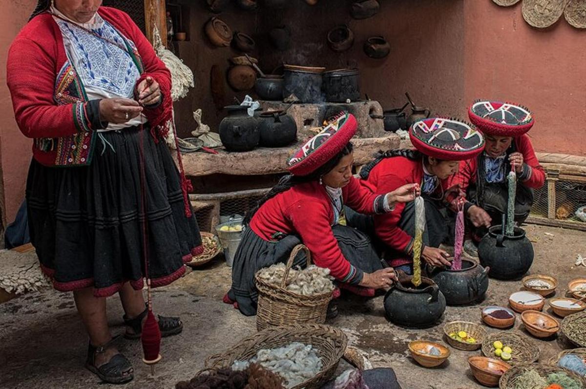 a group of women in traditional clothing preparing food