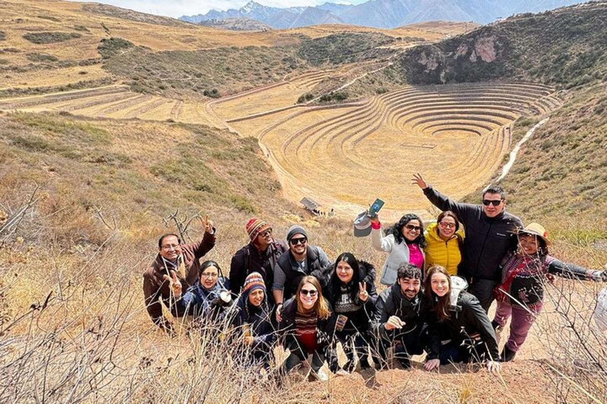 a group of people posing for a picture on a hill