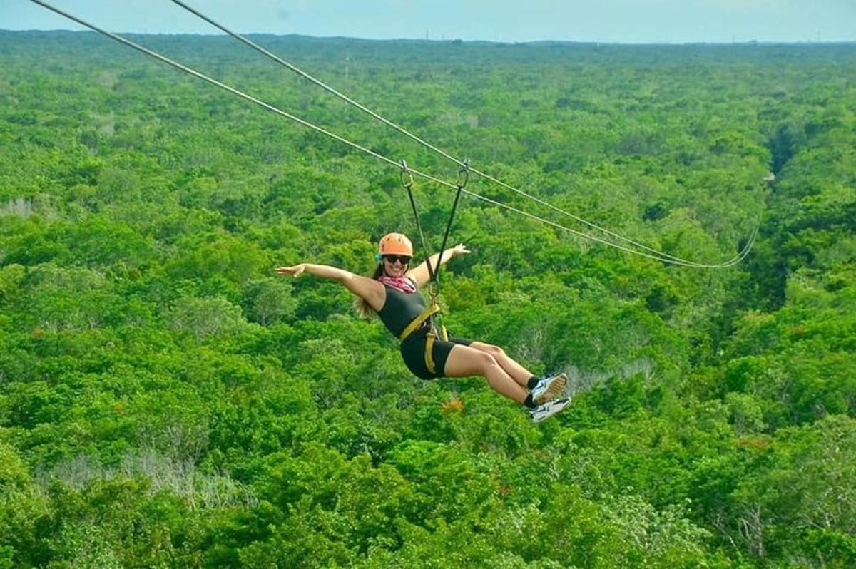 a woman flying through the air on a zip line