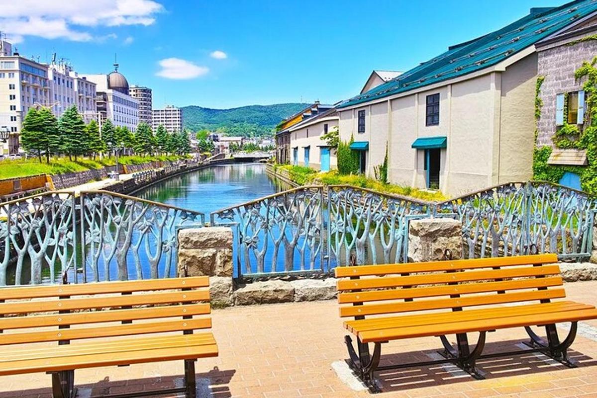 two wooden benches sitting in front of a river
