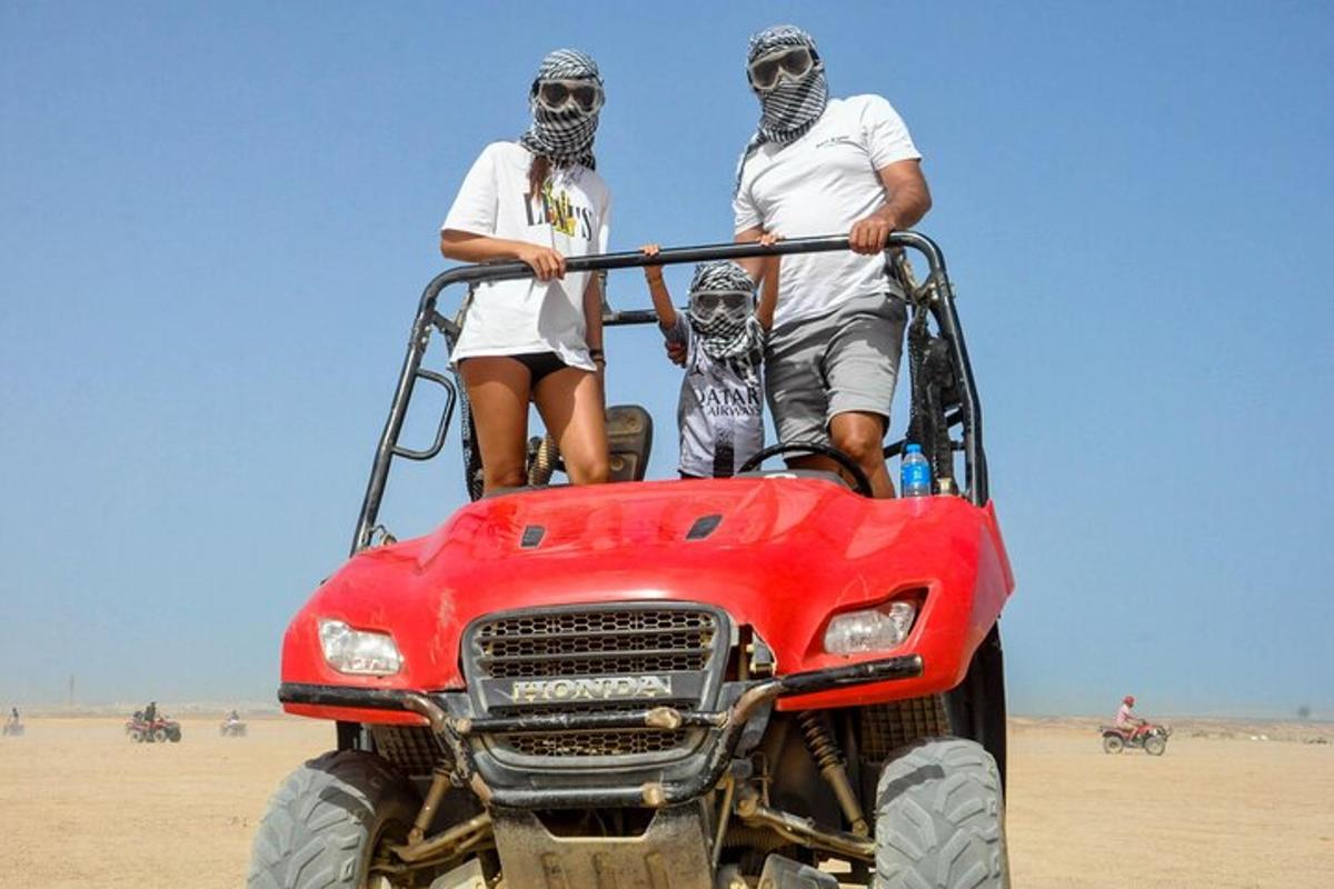 a group of people on a four wheeler in the desert