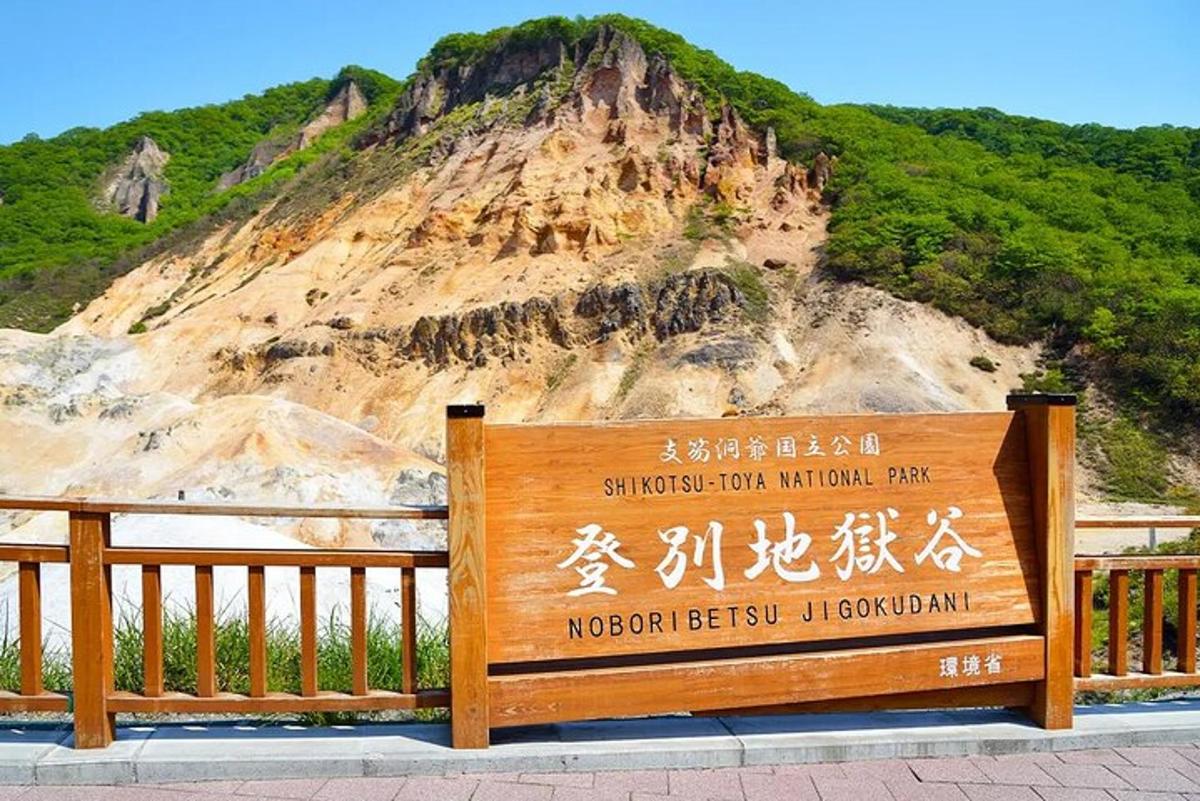 a sign in front of a mountain with a sign