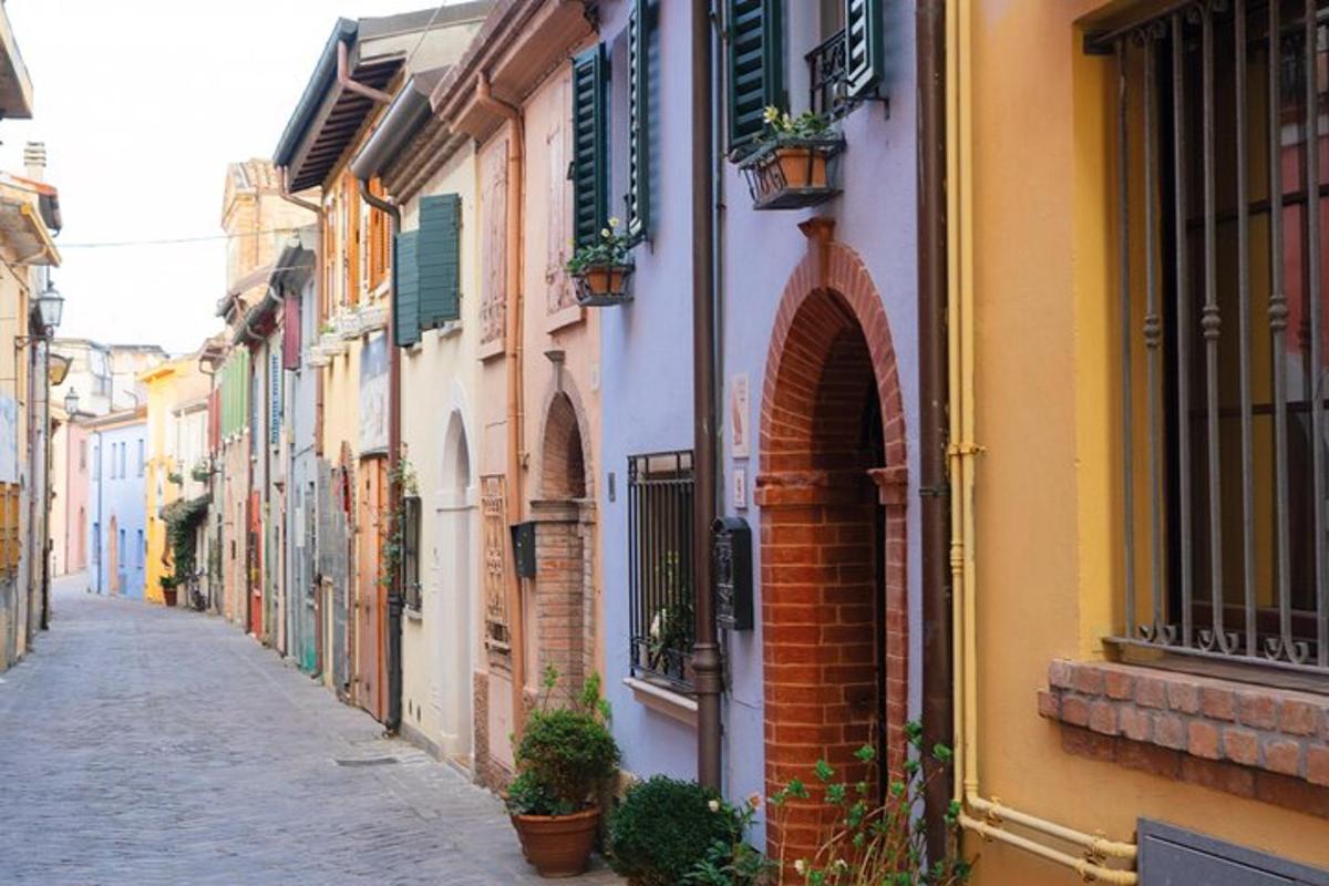 an alley with buildings and potted plants on a street