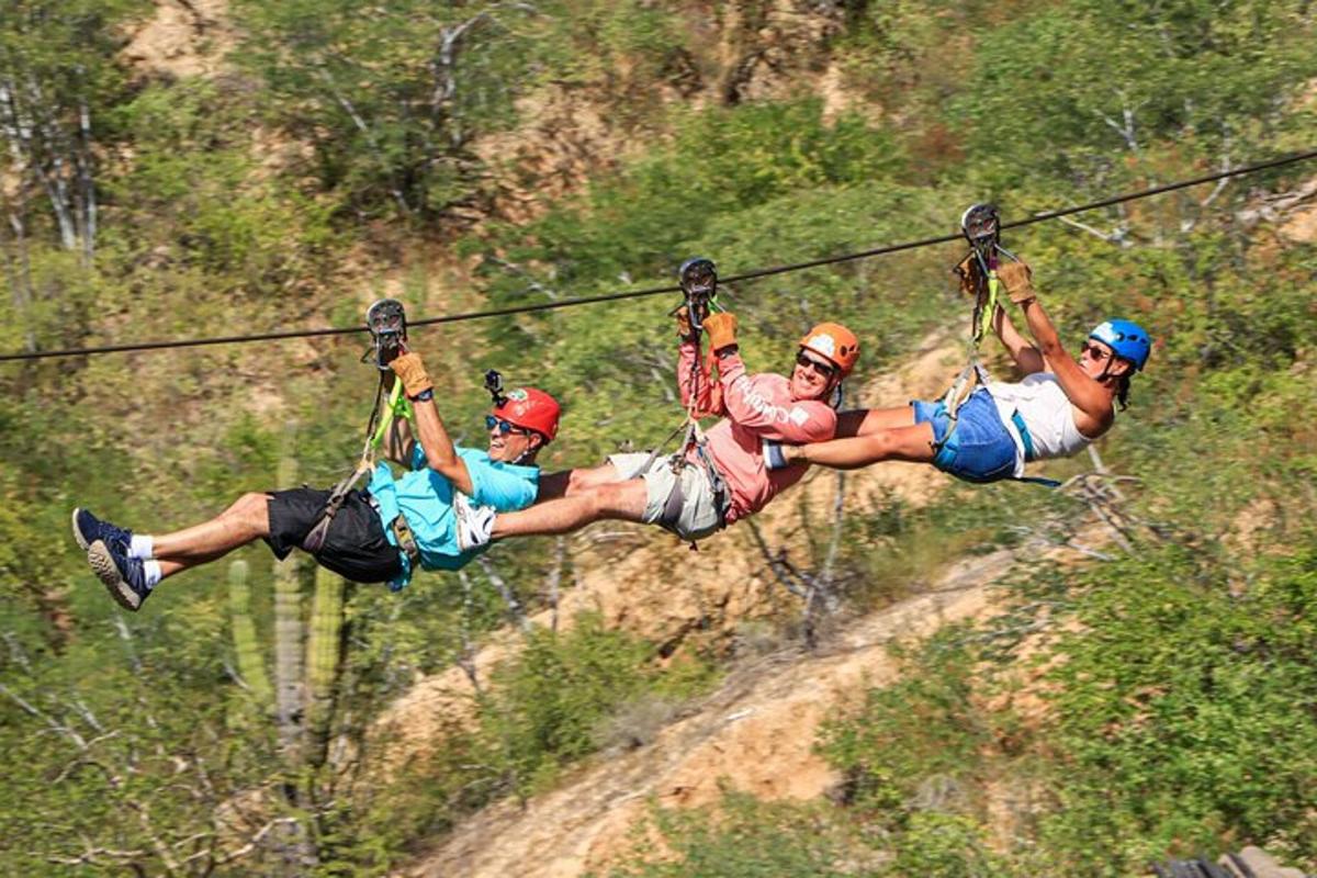 a group of people riding on a zip line