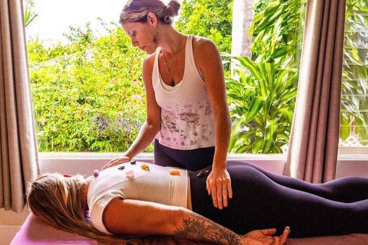 two women are in a meditation session in front of a window