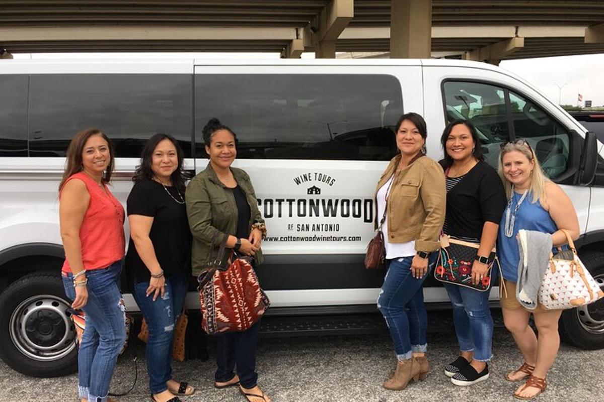 a group of women standing in front of a van