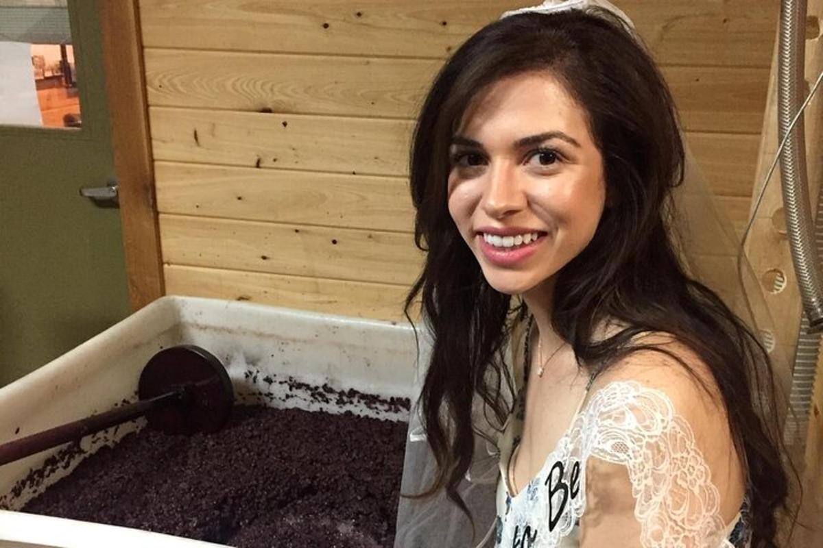 a woman standing next to a bath tub filled with dirt