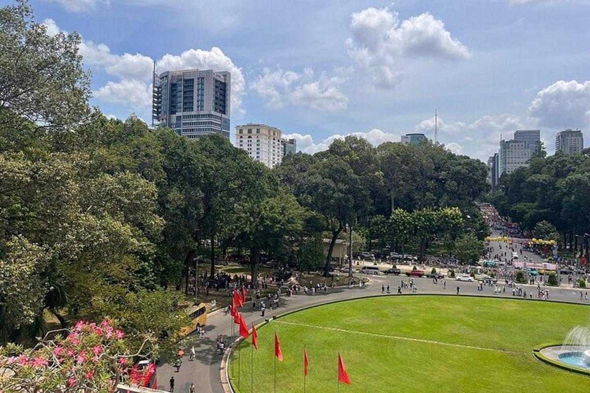 a park in a city with people walking and a fountain