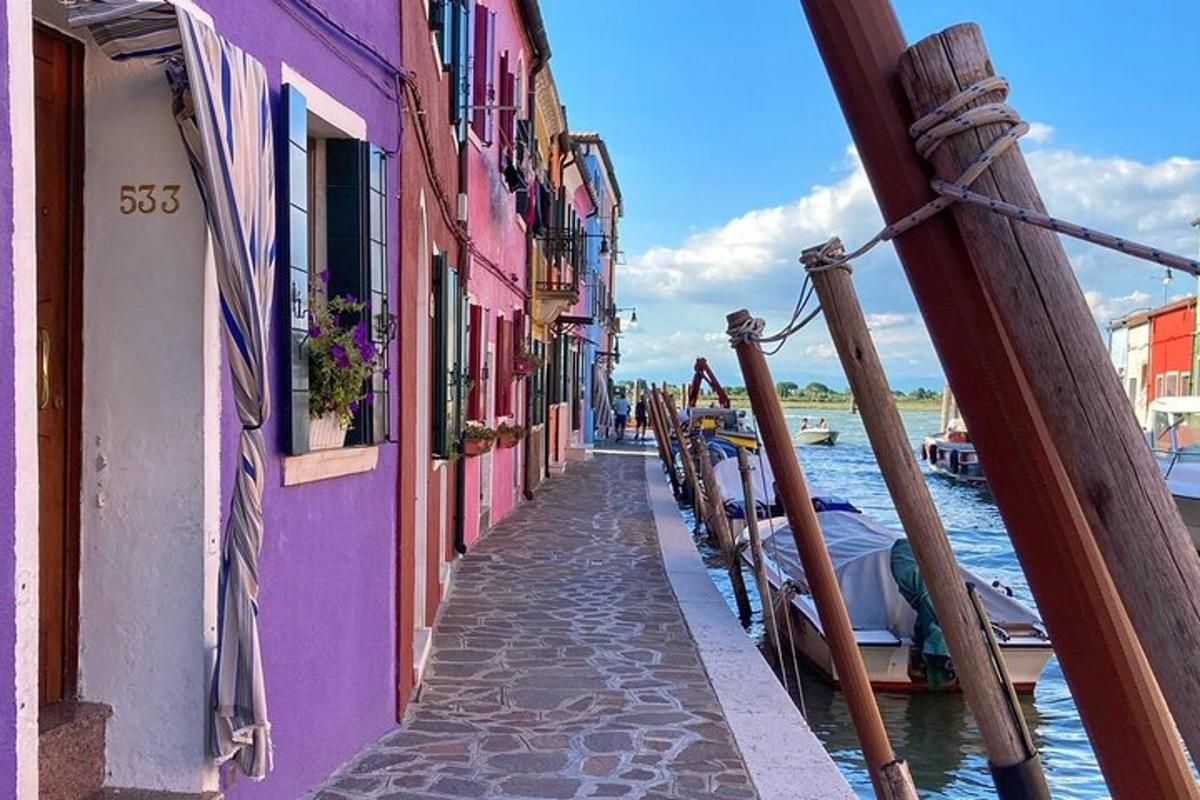 a narrow street with colorful buildings next to the water