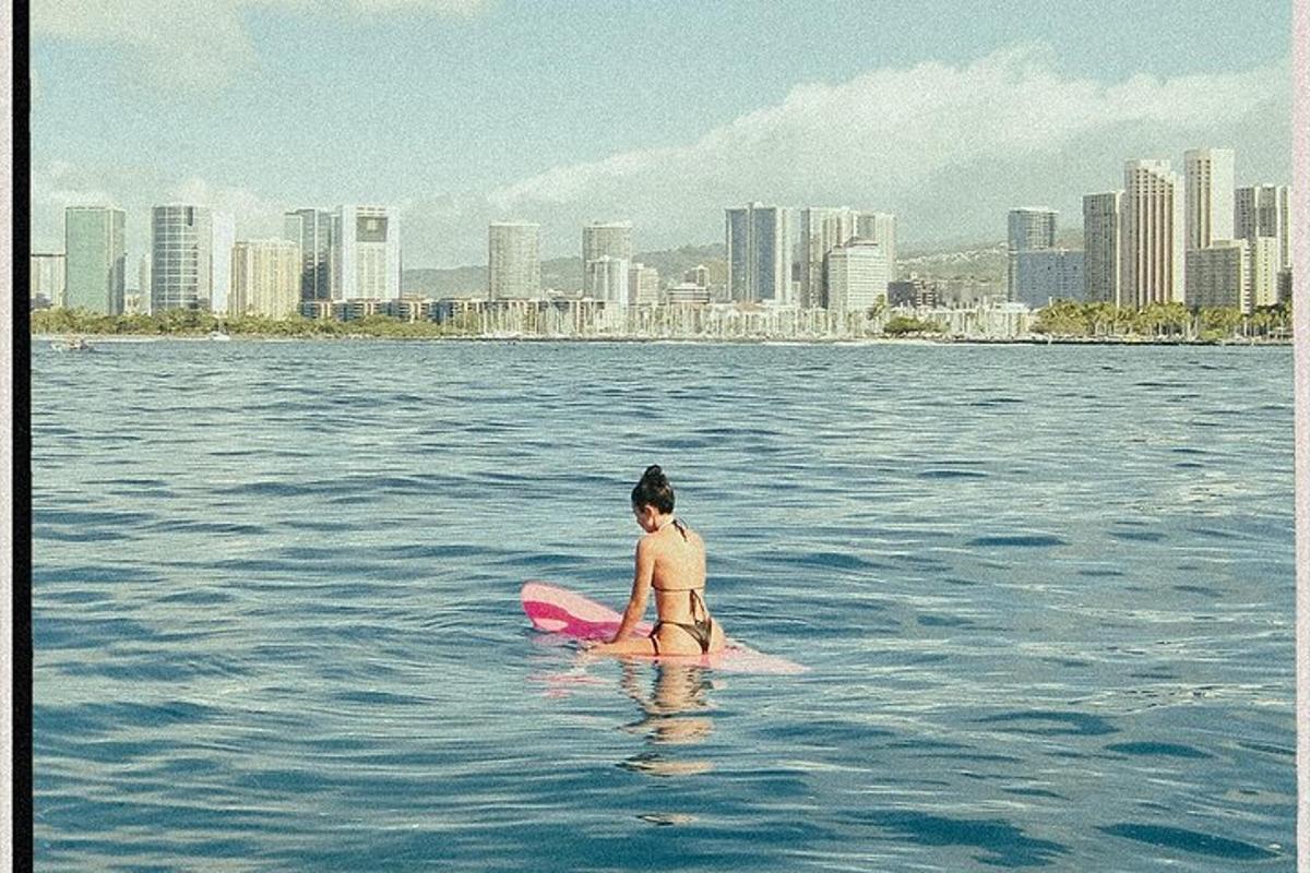 a woman sitting on a surfboard in the water