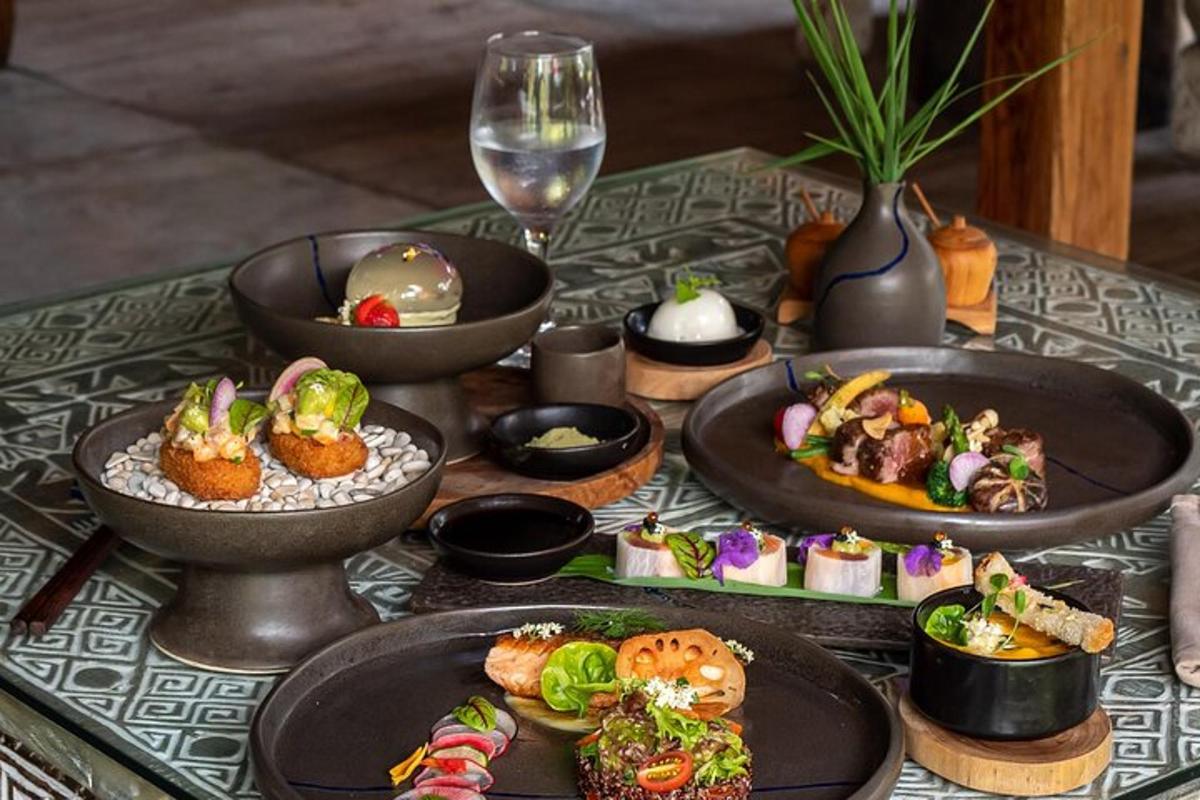 a table with plates of food and a glass of wine
