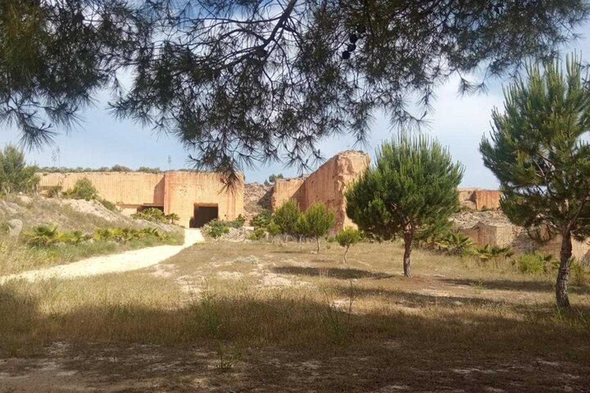 a building in the middle of a field with trees