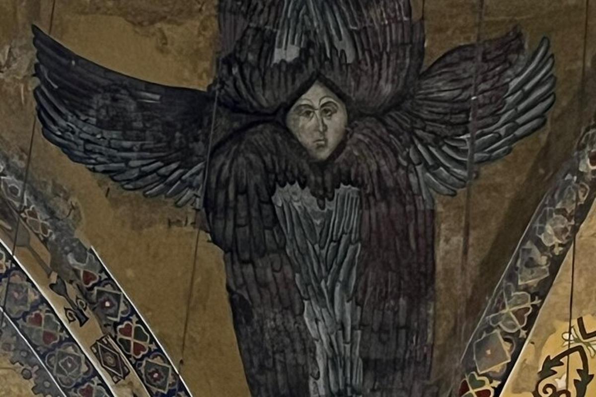 a painting of an angel on the wall of a building